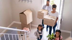 Smiling family unloading boxes while moving into their new home in Bentonville, Arkansas, ready to learn about local pest issues and prevention